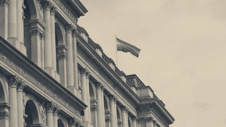 Rainbow pride flag waving from the roof of the classical Foreign Office building in Whitehall, London.