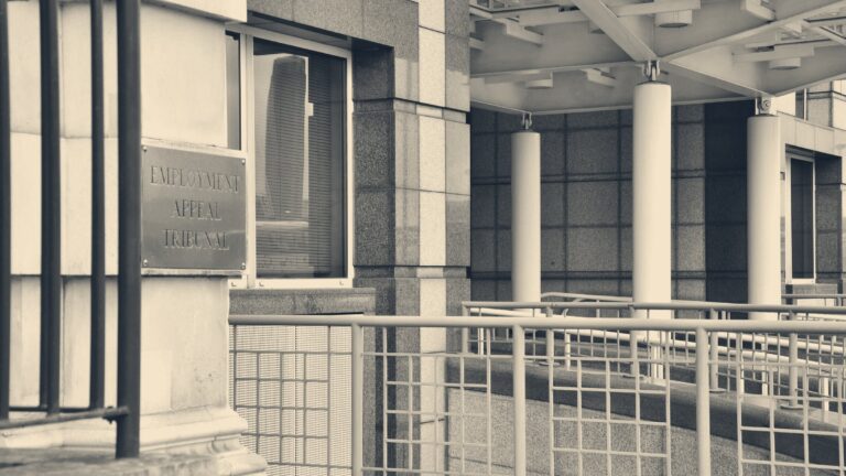 Brass Employment Appeal Tribunal plaque beside the entrance ramp to the tribunal building, London