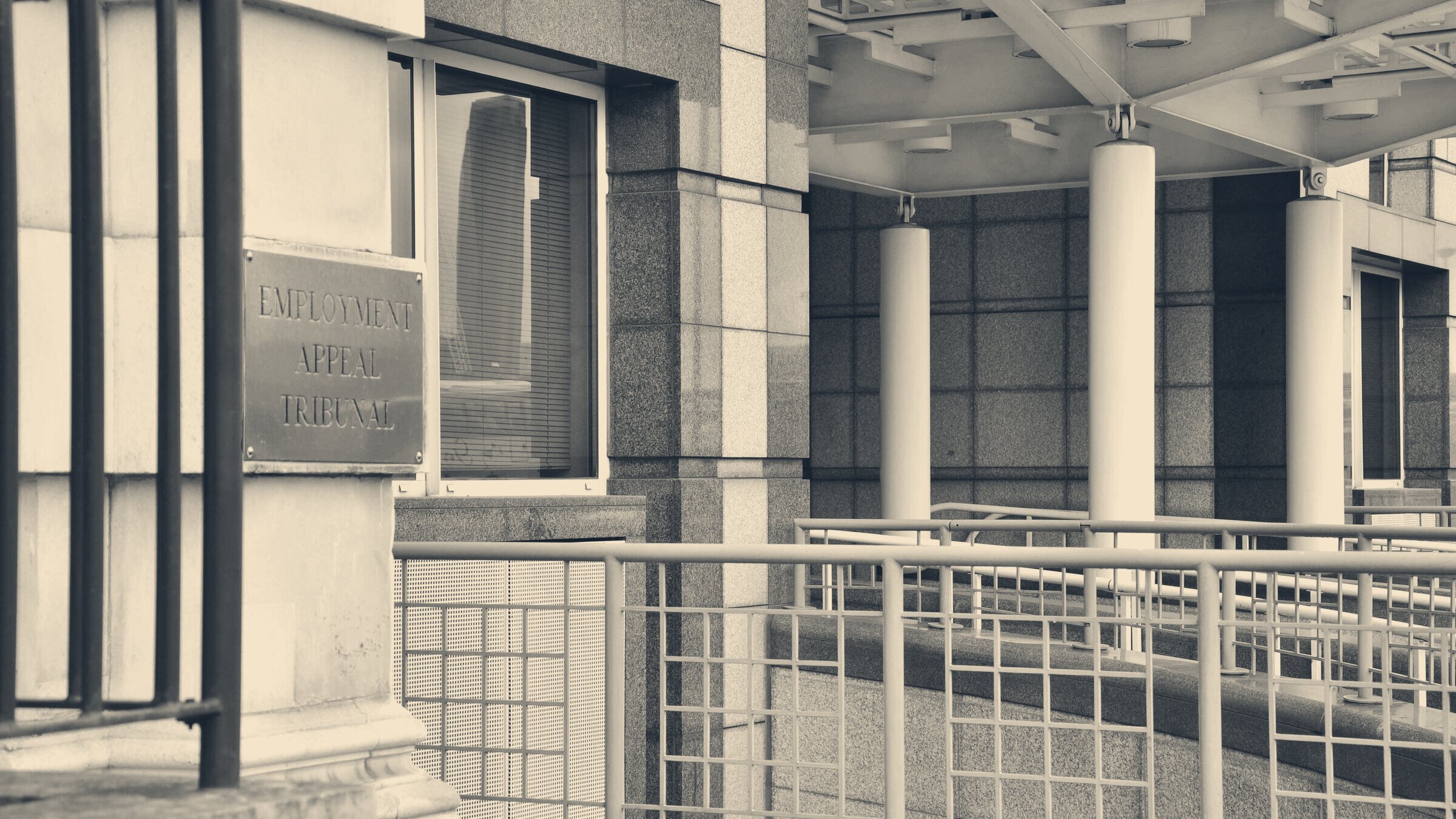 Brass Employment Appeal Tribunal plaque beside the entrance ramp to the tribunal building, London
