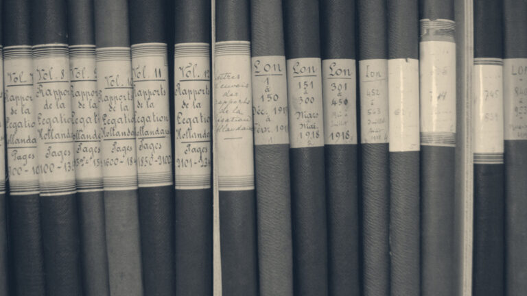 Bound archive record volumes on a shelf, their spines labelled by hand with dates from 1917 to 1918