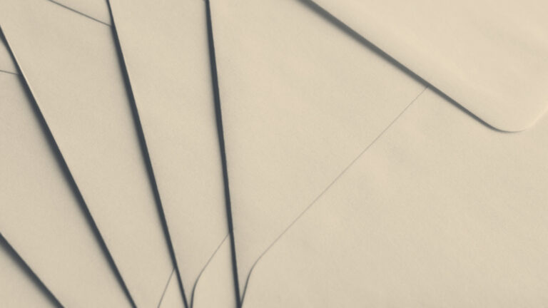 A fan of overlapping manila envelope flaps with soft diagonal shadows, like a stack of pay packets