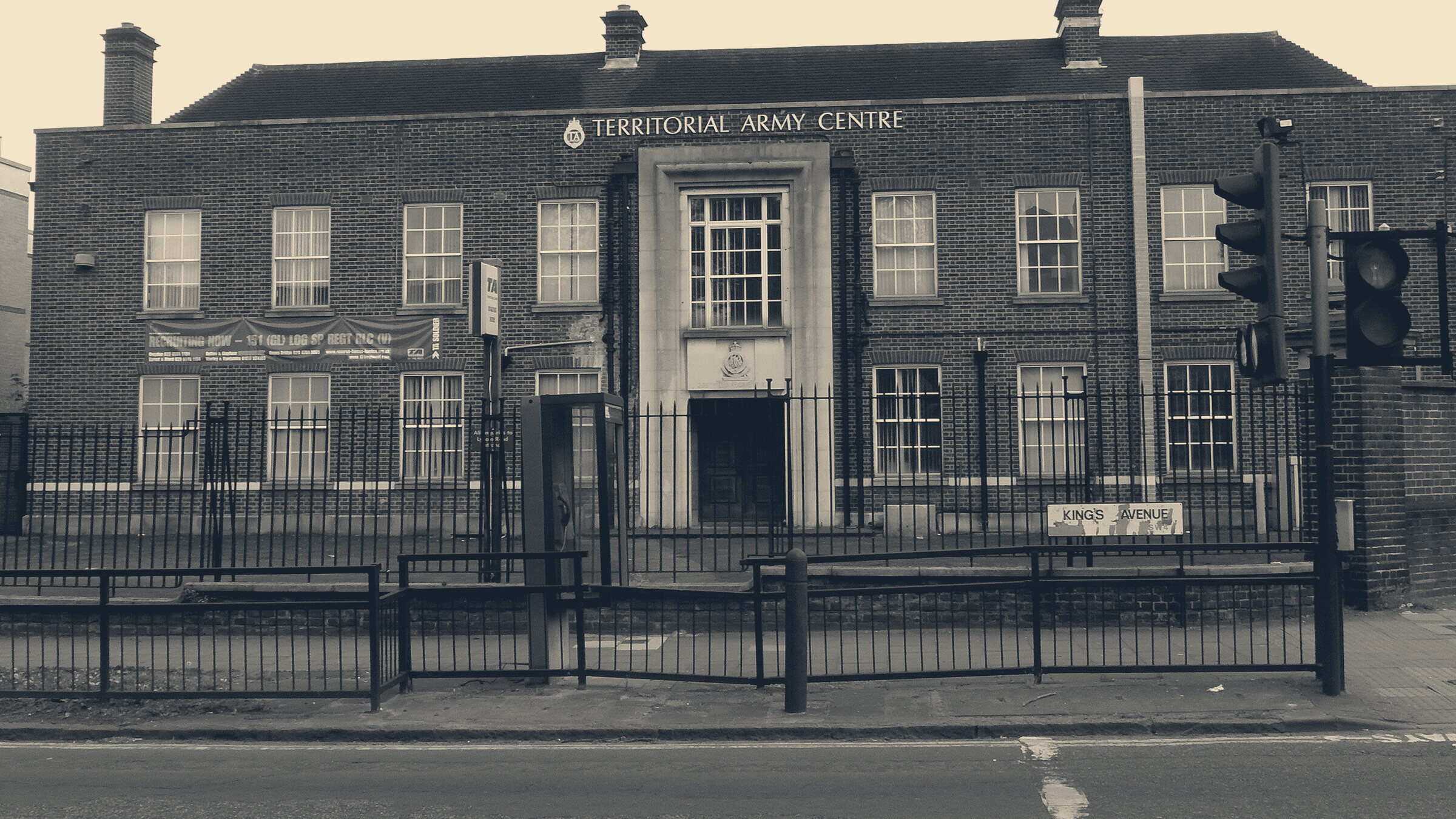 Territorial Army Centre on Kings Avenue, Clapham: a red-brick building with a TA recruiting banner, behind railings and traffic lights