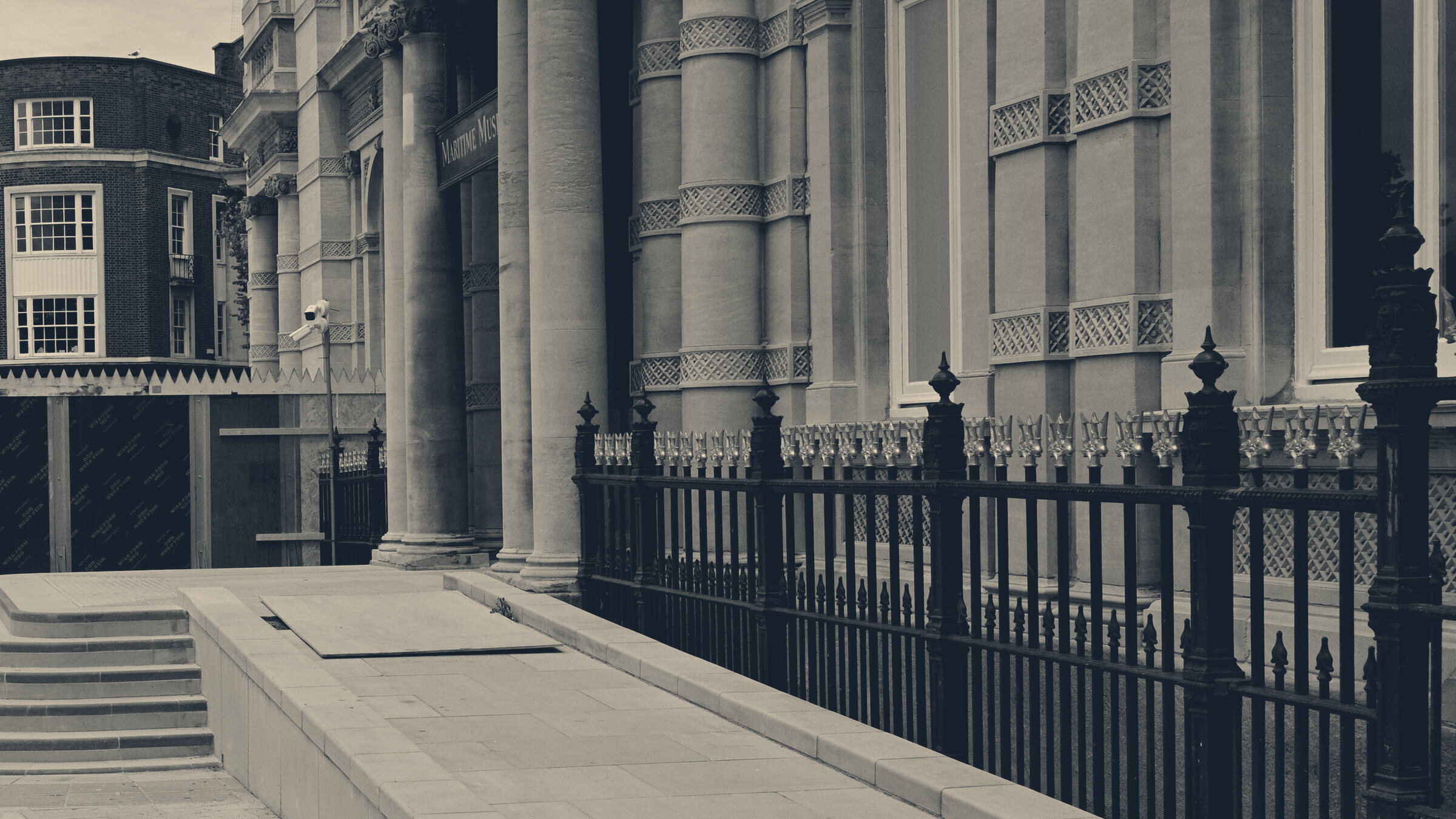 A new paved wheelchair ramp sweeps up beside steps to a columned museum entrance in Hull