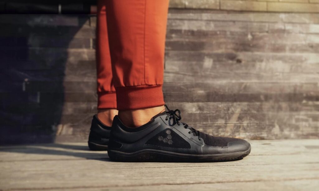 Foot comfortably spread in a wide toe box barefoot shoe, illustrating natural foot shape.